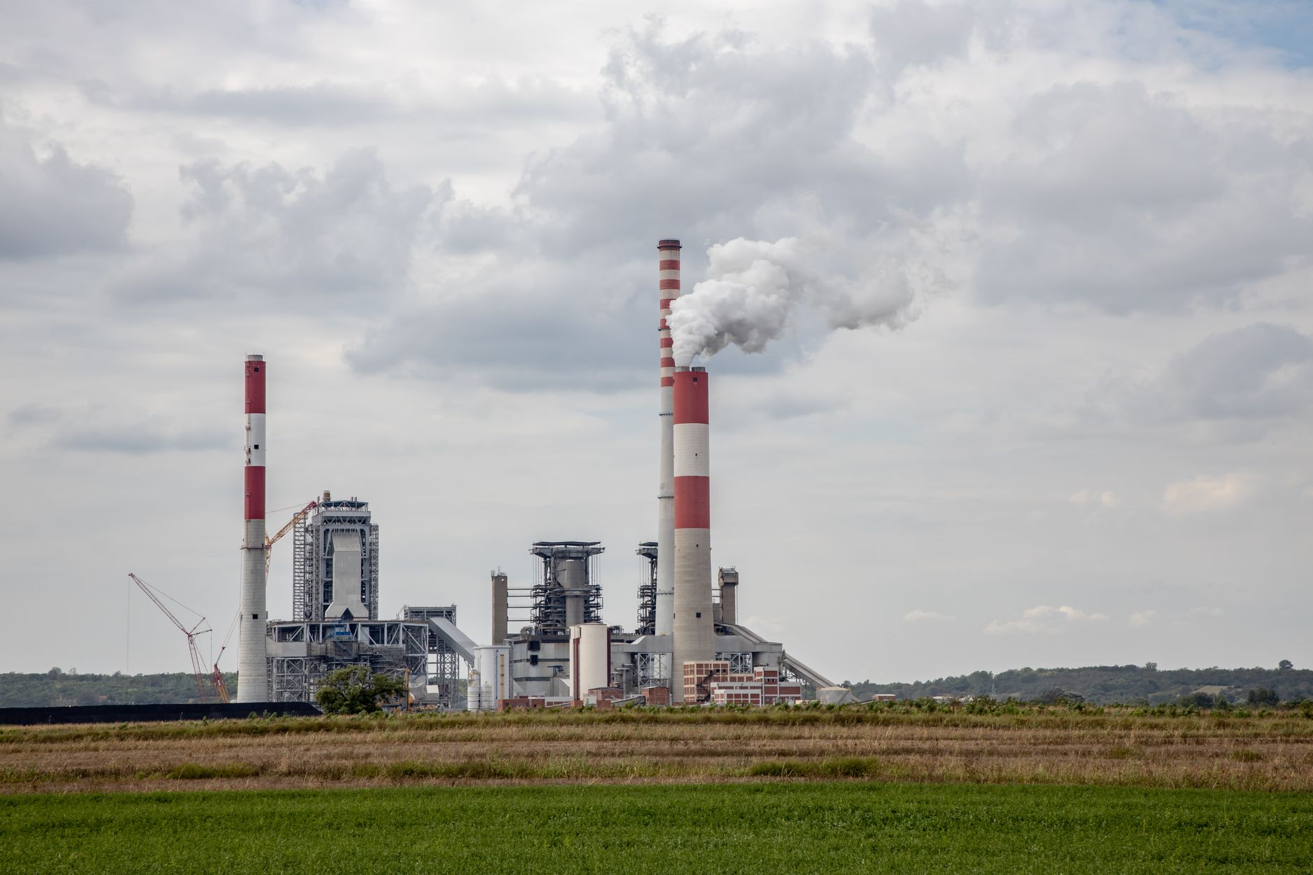 Coal Phase-Out Planning in Asia: Reconciling Policy Timelines with Grid Reality — coal power plant smokestacks aerial view