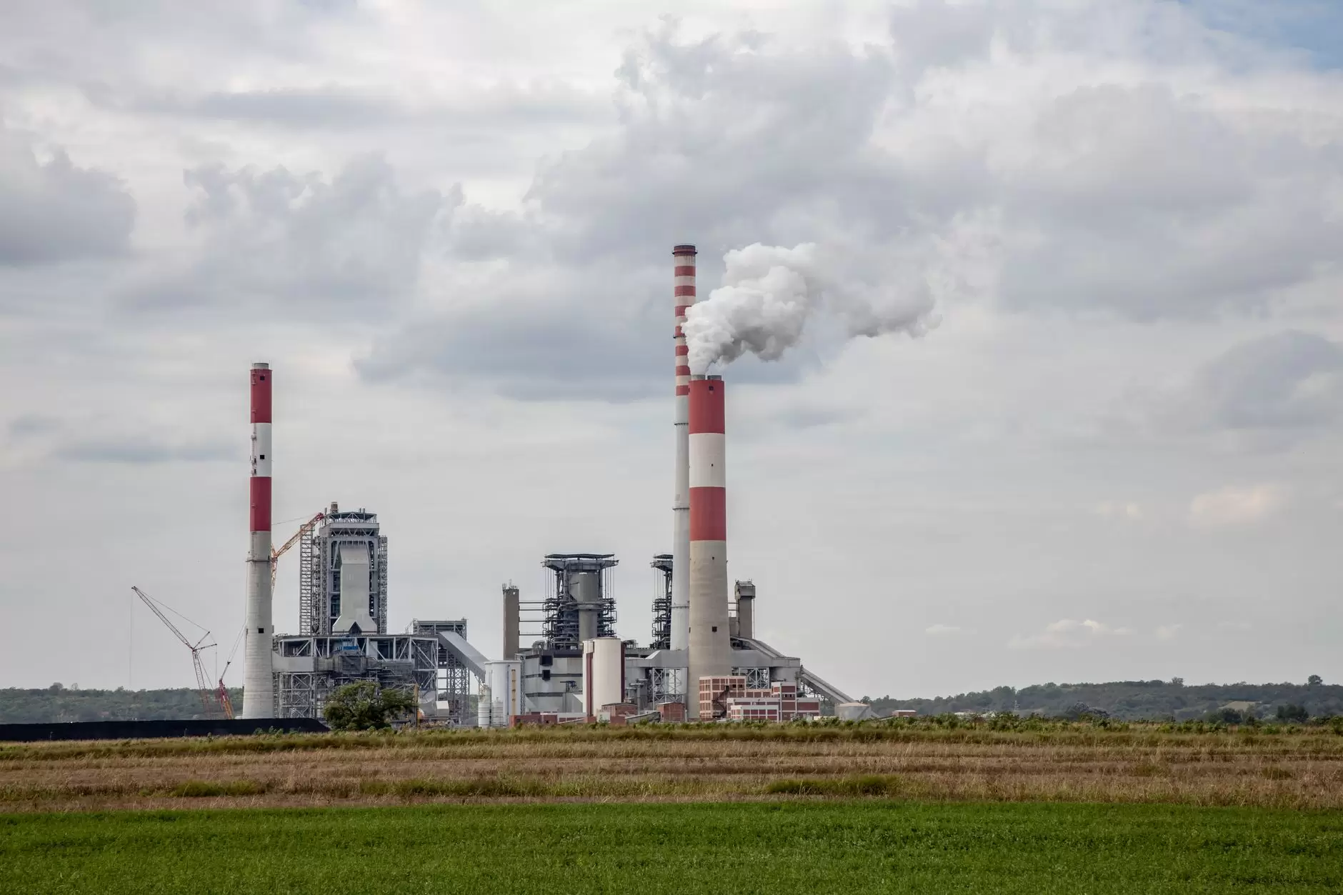 Coal Phase-Out Planning in Asia: Reconciling Policy Timelines with Grid Reality — coal power plant smokestacks aerial view