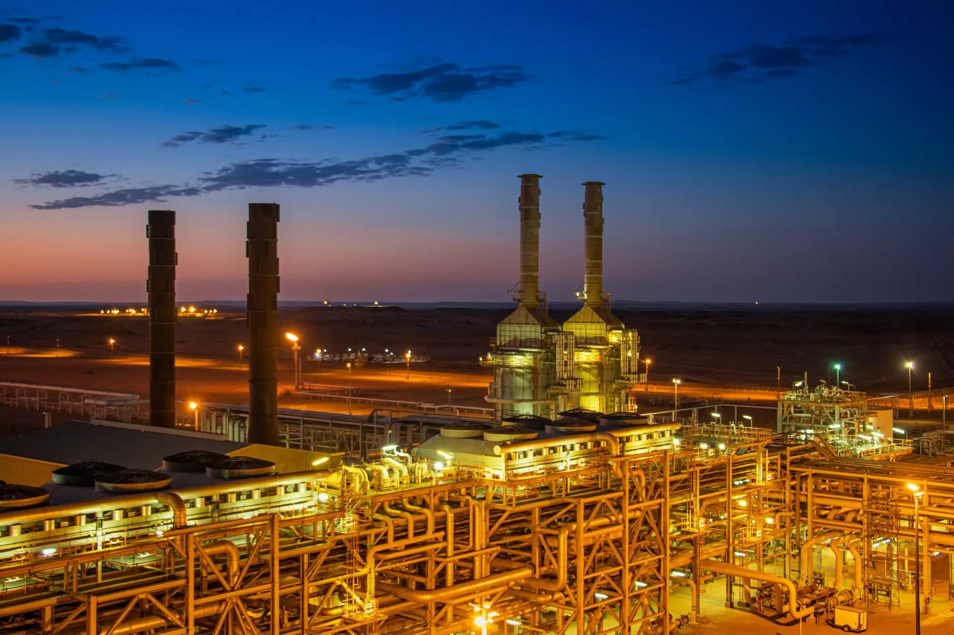 Natural Gas in the Energy Transition: Bridge Fuel or Stranded Asset Risk? — natural gas combined cycle power plant at dusk
