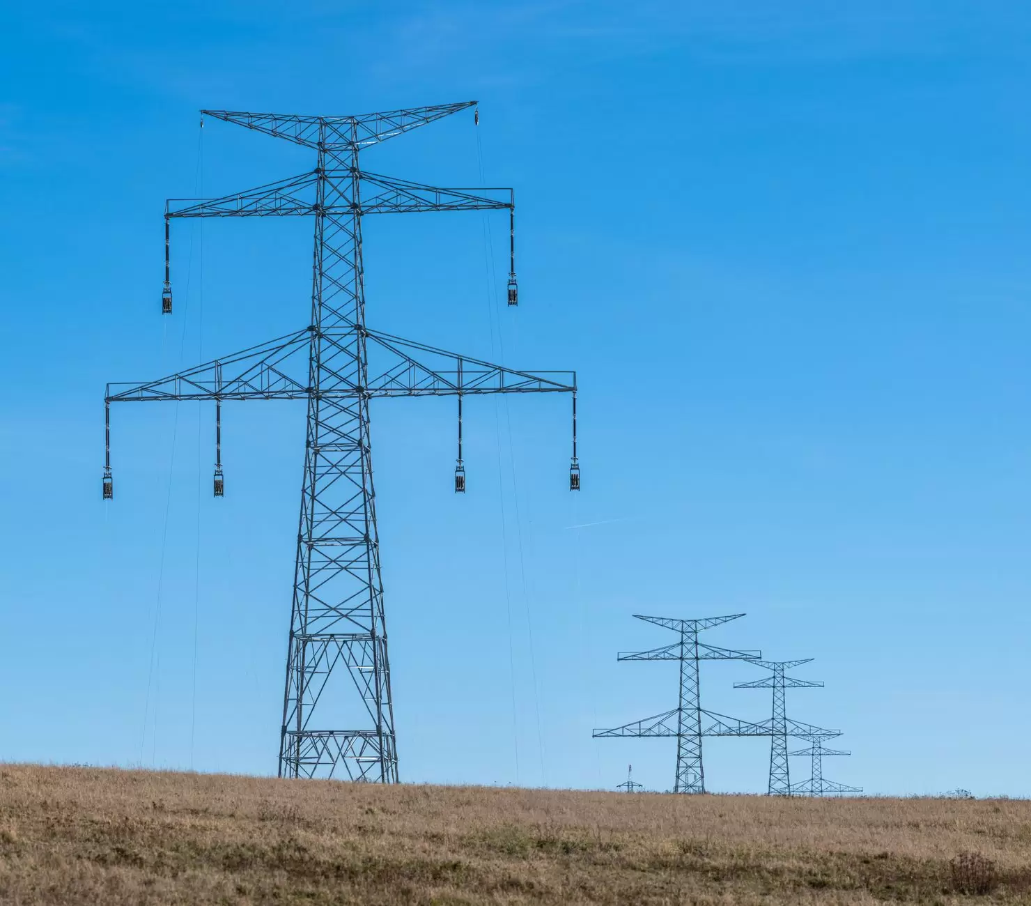 The Hidden Cost of Grid Congestion in Modern Electricity Markets — high voltage power lines transmission towers