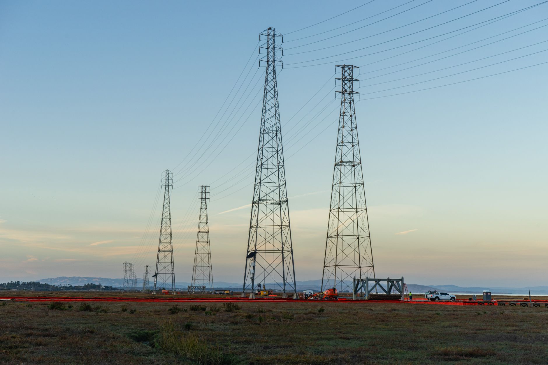 Grid Automation: From Manual Switching to Self-Healing Networks — high-voltage distribution power lines and utility switching equipment at dusk
