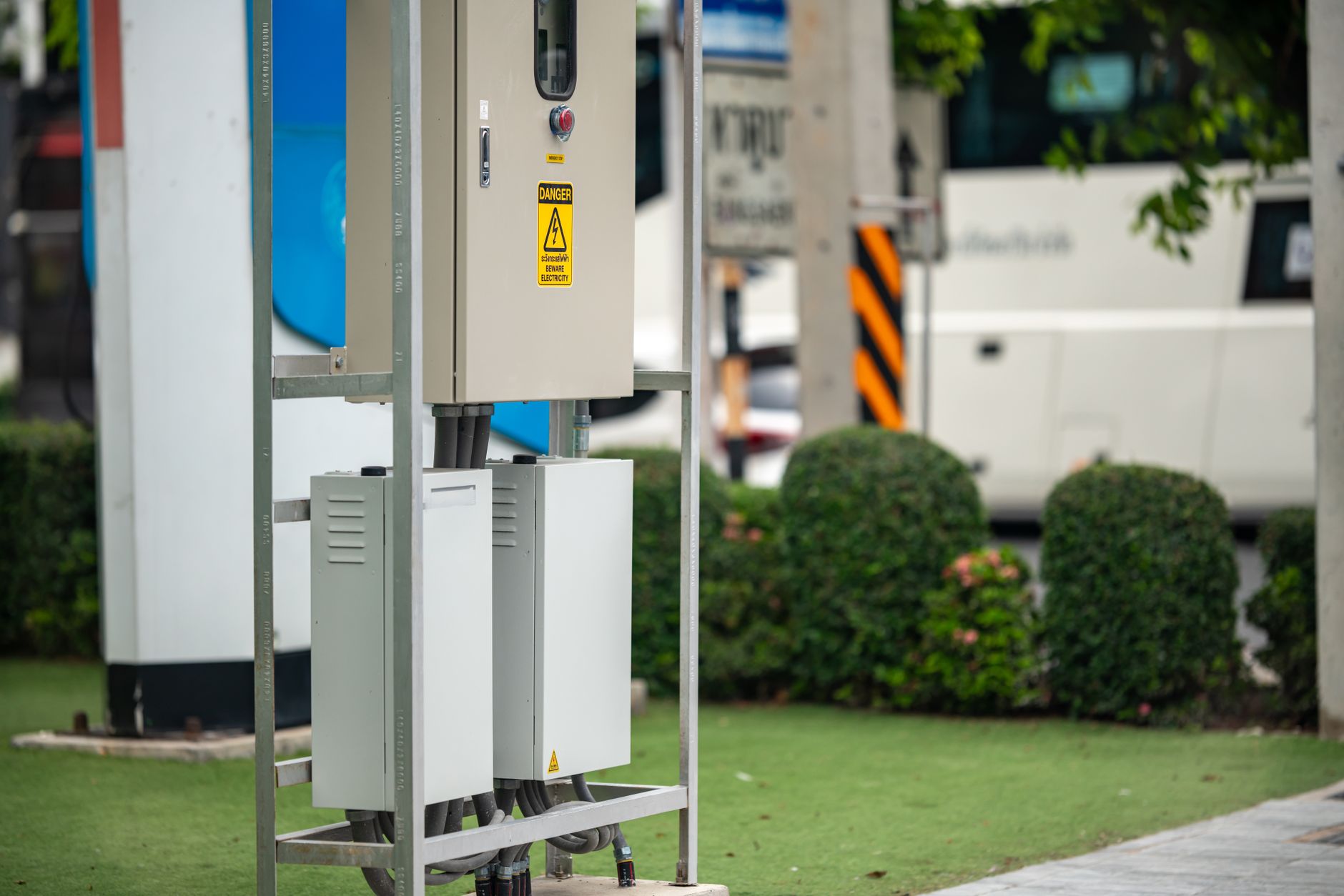 Why Electricity Demand Is Growing Again: Electrification and the Grid — electric vehicle charging at a suburban street in the evening with homes and utility poles