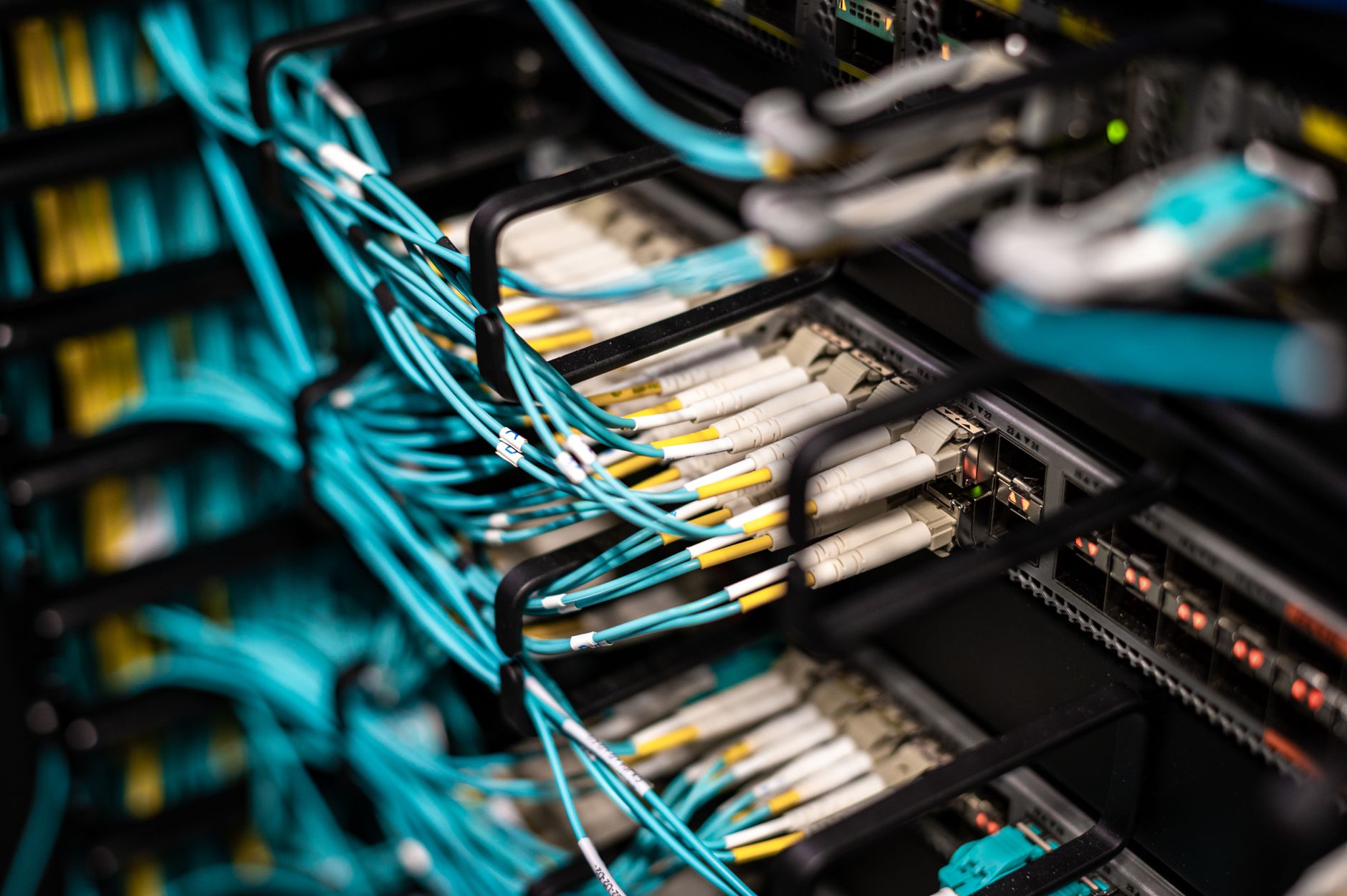 The Power and Cooling Challenges of High-Density AI Server Racks — high-density server racks with visible cables and power distribution equipment in a modern data center