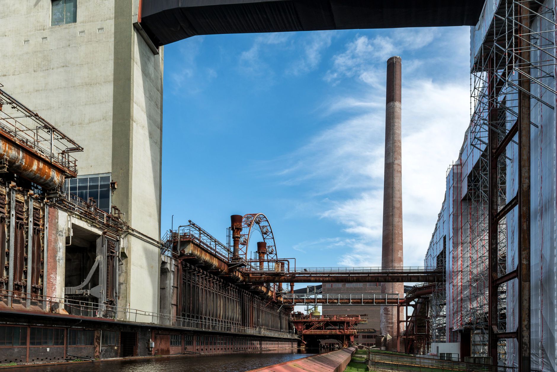 Carbon Markets and Offsets: 2025 Update — industrial smokestacks and steel mill facilities beneath hazy sky