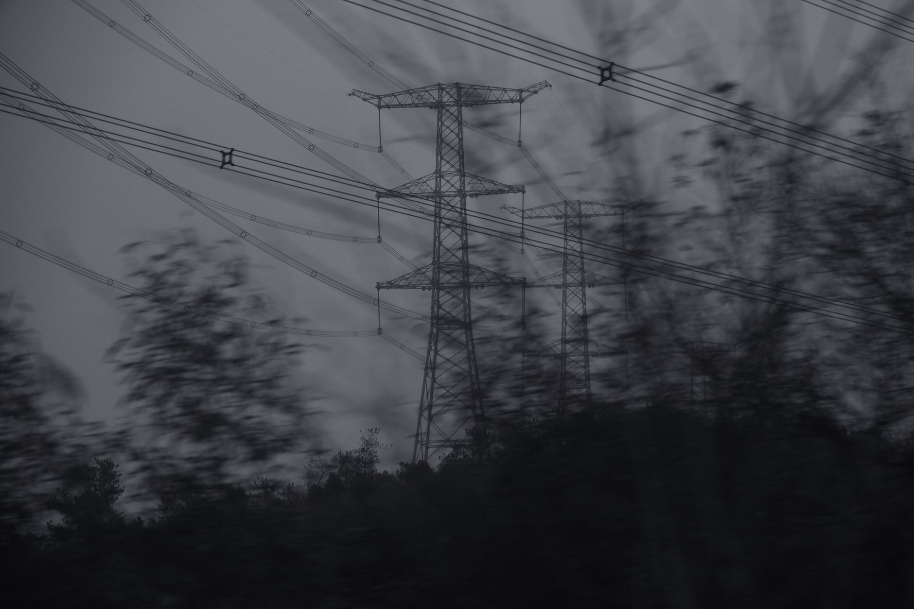 Harmonizing Grid Codes in ASEAN: The Technical Key to Regional Power Integration — high-voltage transmission towers crossing a tropical Southeast Asian landscape