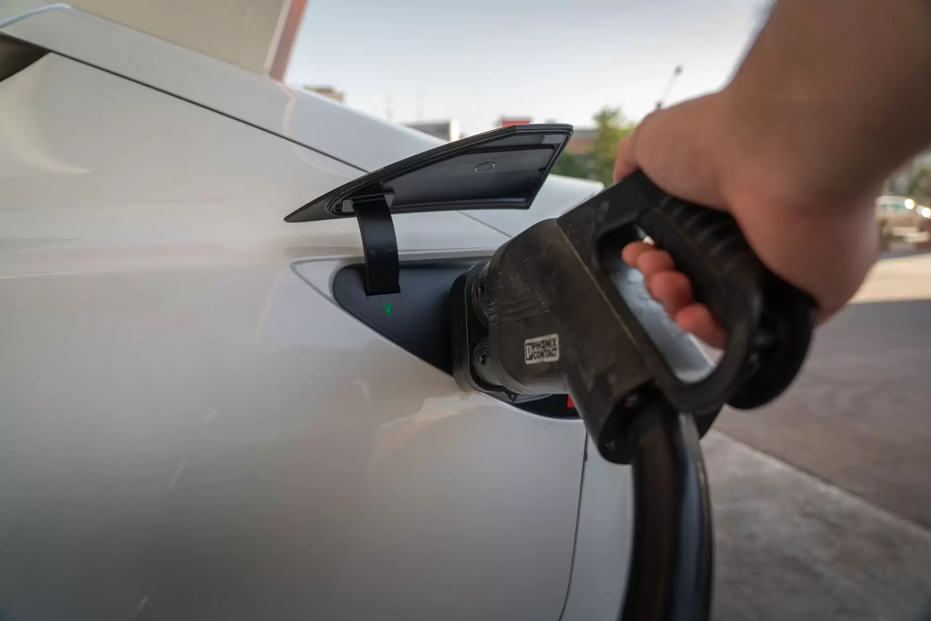 EV Charging Impact on the Grid: Separating kW Reality from the Headlines — electric vehicles charging outside suburban homes at dusk