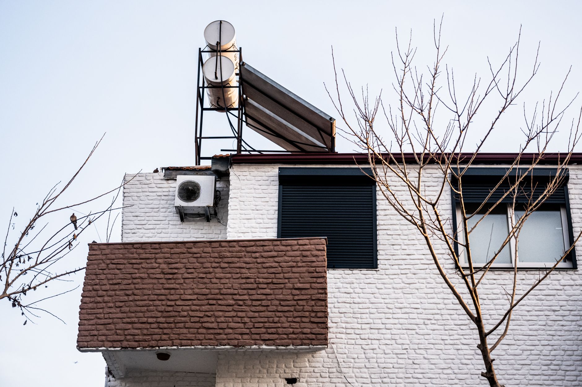 Heat Pumps and Peak Demand: What Electrified Heating Means for the Grid — modern air source heat pump unit mounted outside a residential house in winter
