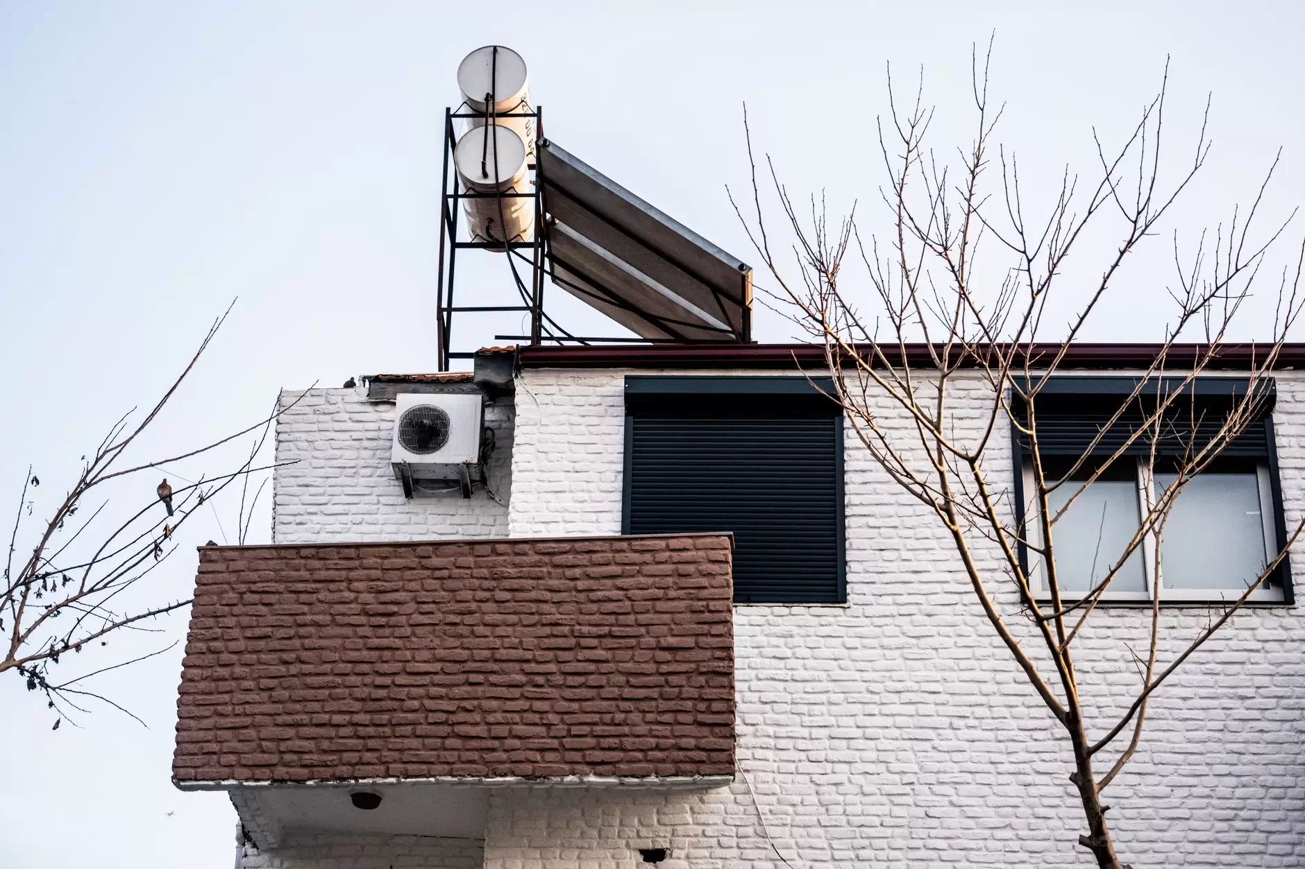 Heat Pumps and Peak Demand: What Electrified Heating Means for the Grid — modern air source heat pump unit mounted outside a residential house in winter