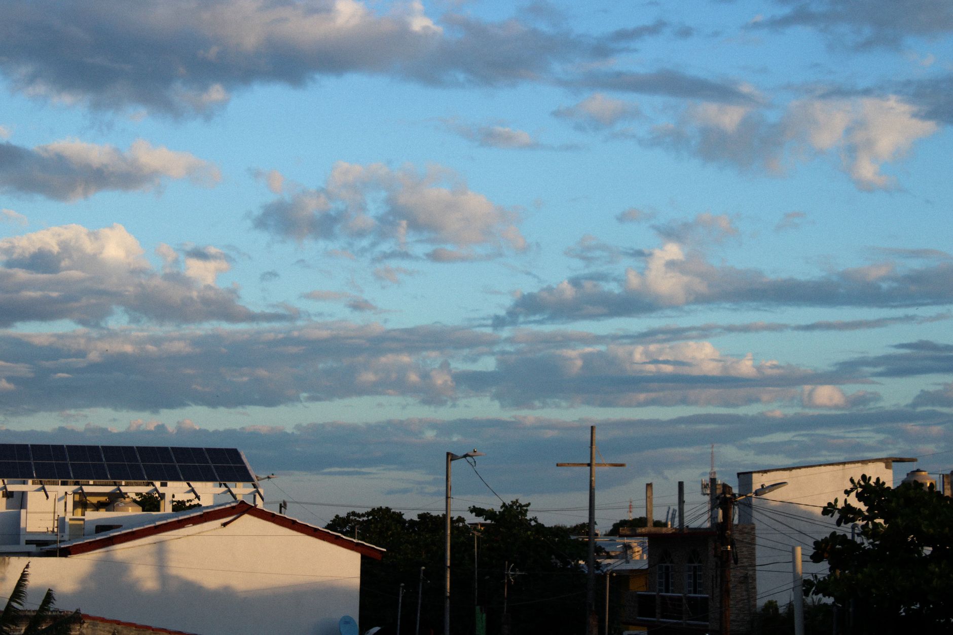 Sri Lanka's Energy Crisis and the Push for Renewables: Can Distributed Solar Provide Energy Security? — rooftop solar panels on homes and commercial buildings in a dense tropical city