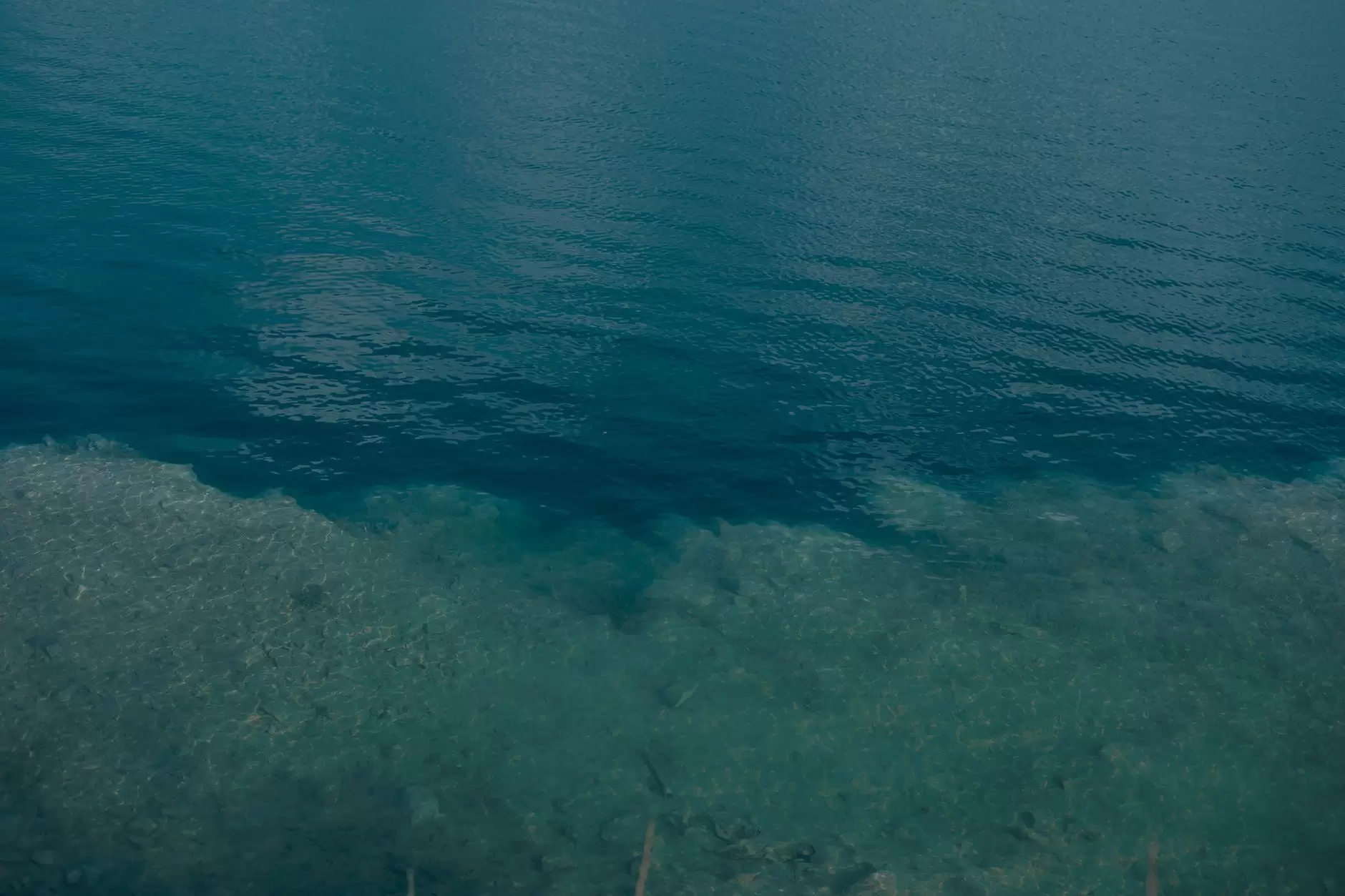 Marine Energy Technologies: Tidal Stream vs. Wave Power at the Megawatt Scale — underwater tidal stream turbine mounted on seabed in clear coastal water