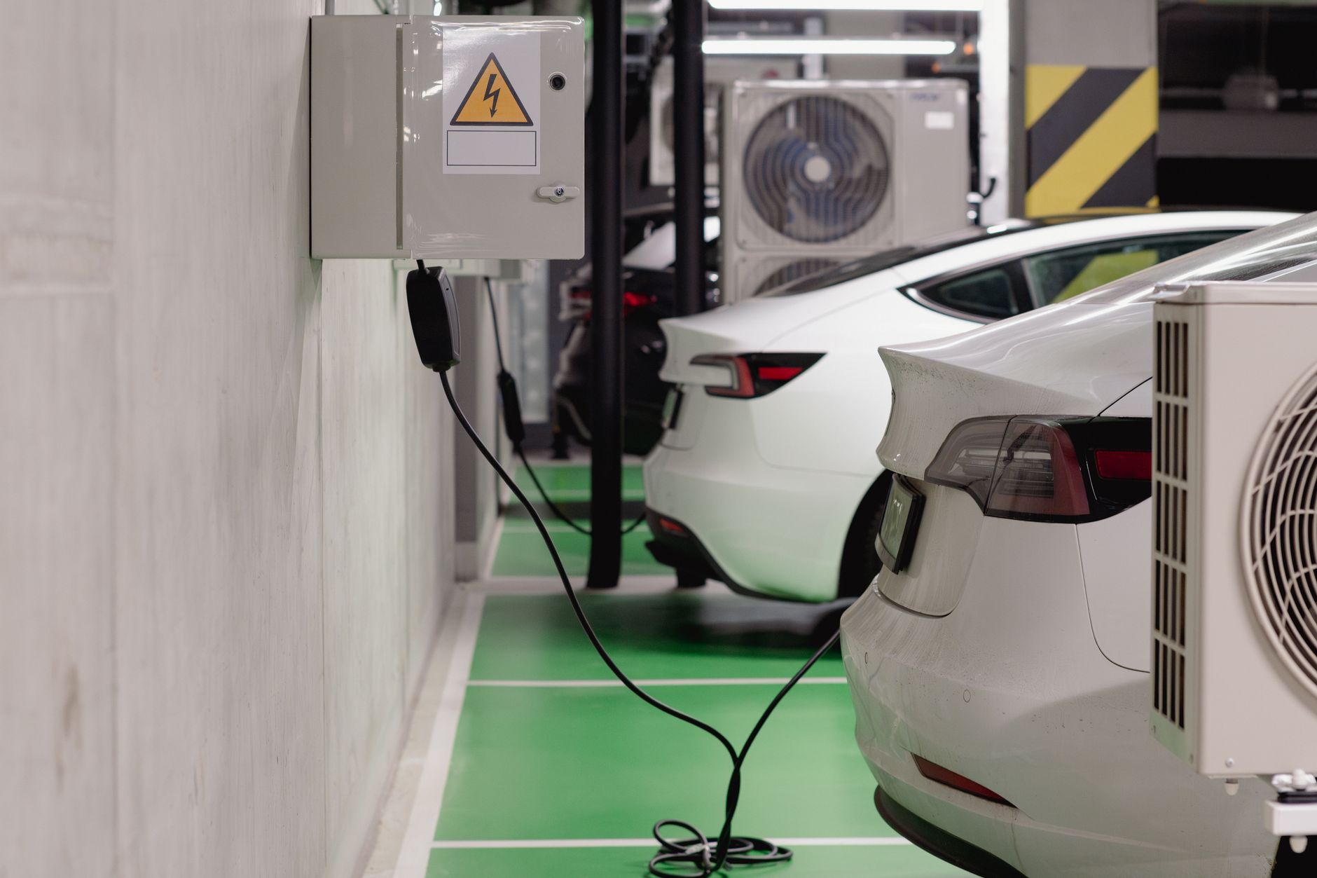 Vehicle-to-Grid: What It Takes to Use EV Batteries as a Grid Asset — electric vehicle charging at a commercial fleet depot with multiple cars and charging stations