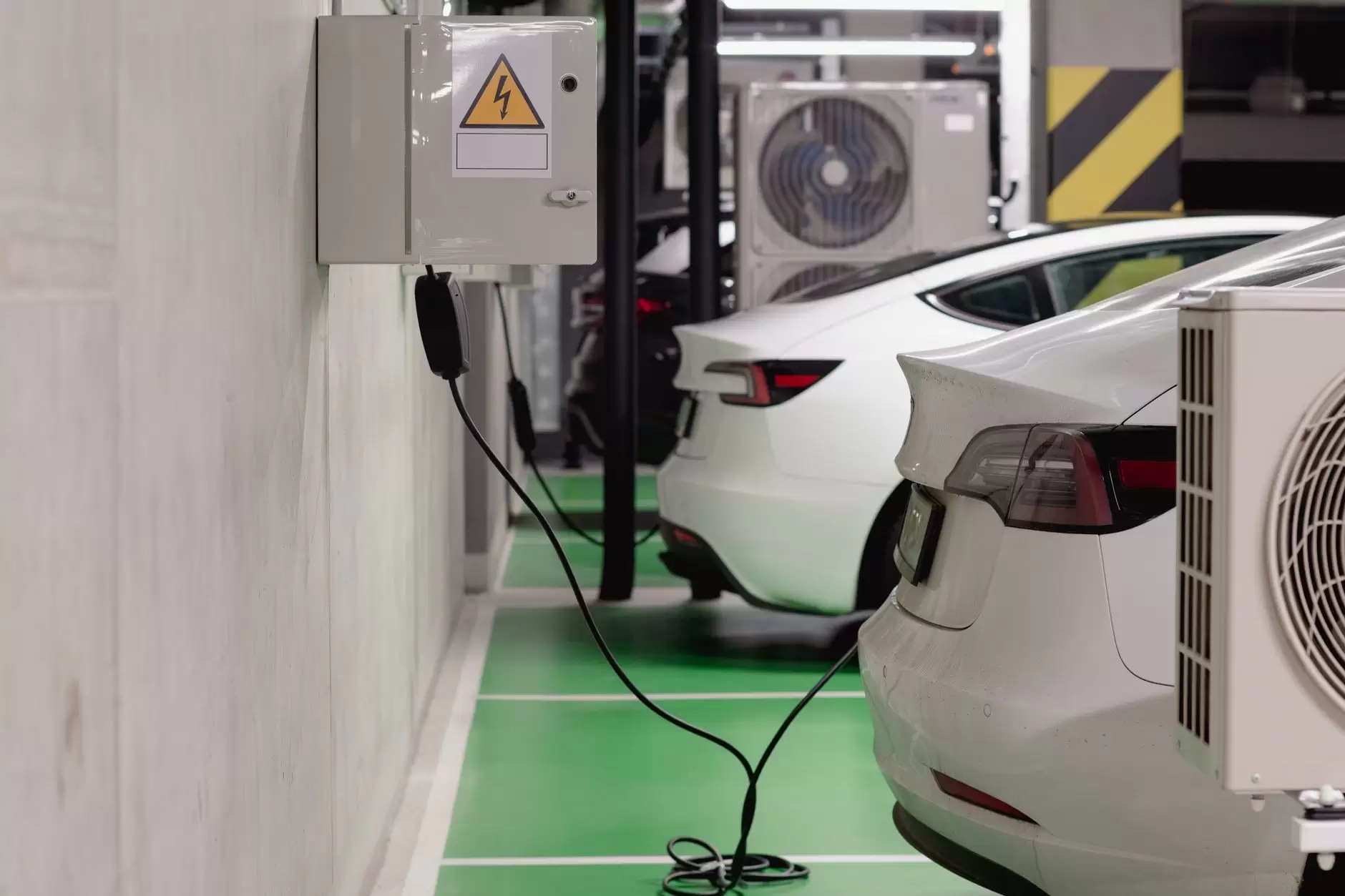 Vehicle-to-Grid: What It Takes to Use EV Batteries as a Grid Asset — electric vehicle charging at a commercial fleet depot with multiple cars and charging stations