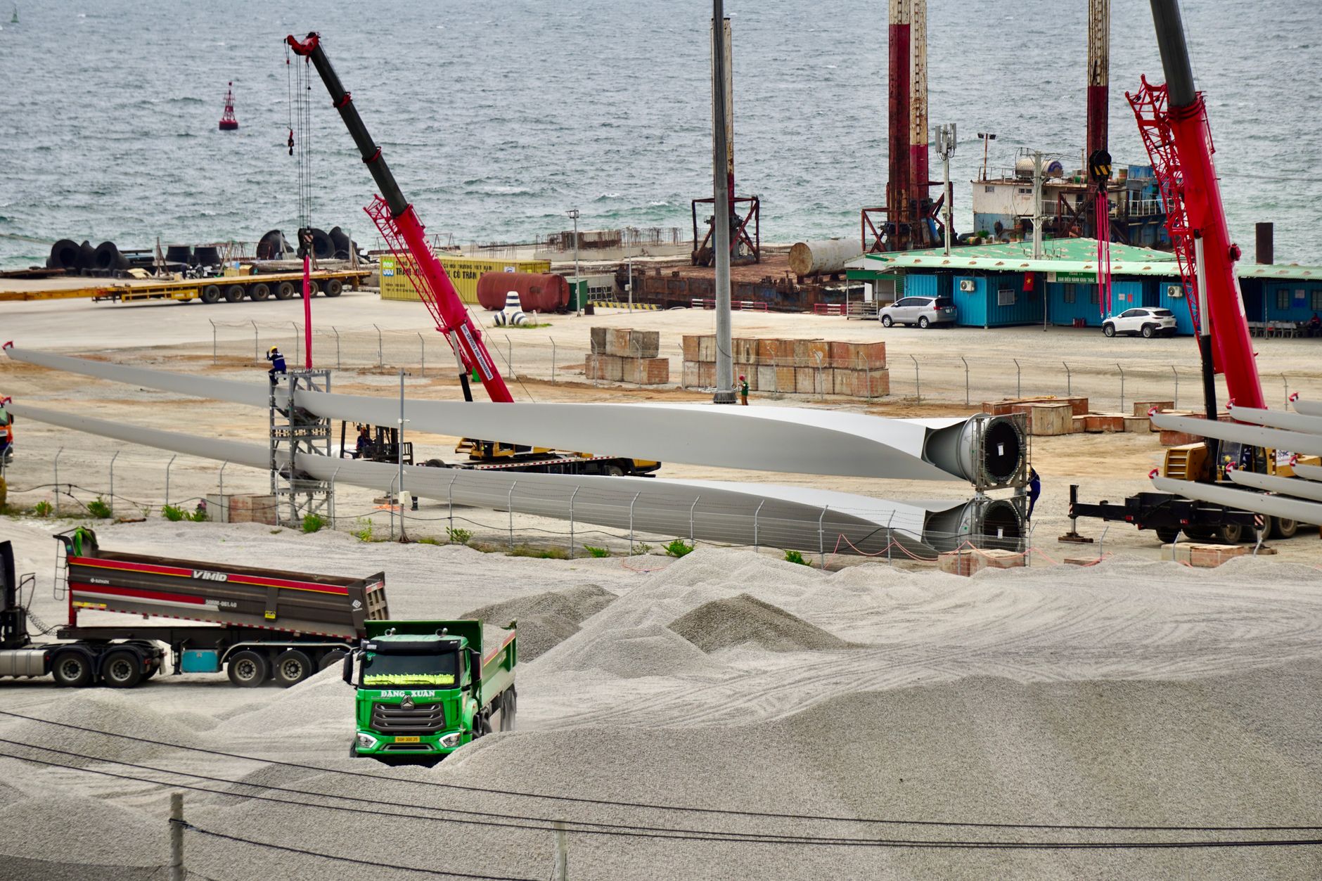 Wind Turbine Blade Recycling: The End-of-Life Bill Nobody Has Paid — large wind turbine blades stored at an industrial decommissioning site