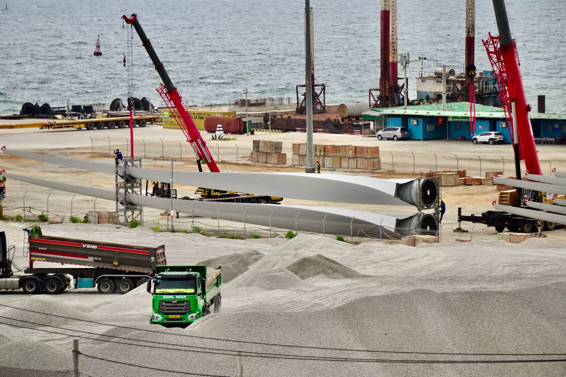 Wind Turbine Blade Recycling: The End-of-Life Bill Nobody Has Paid — large wind turbine blades stored at an industrial decommissioning site